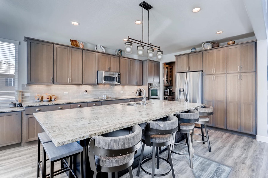 Traditional kitchen with warm gray cabinets and large granite island